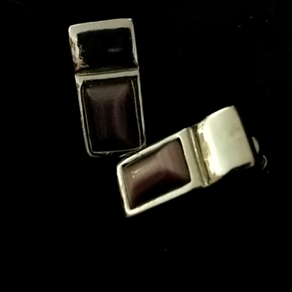 Silver tone earrings with purple stone.